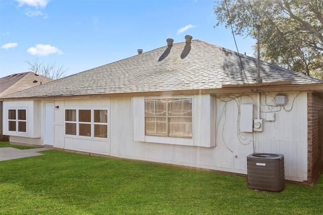 view of side of property with a yard and cooling unit