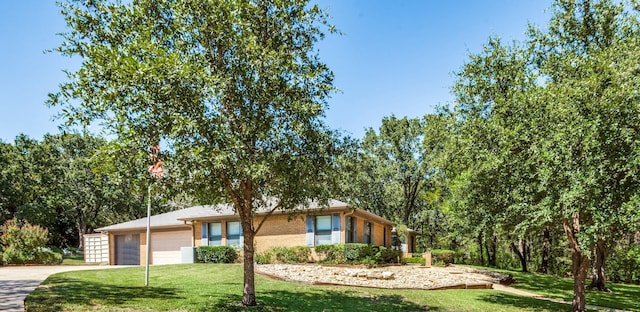 single story home with a garage and a front lawn