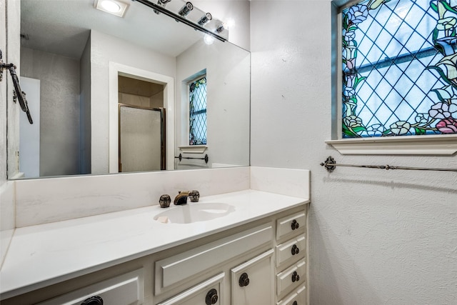 bathroom featuring vanity and a shower with shower door