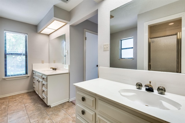 bathroom featuring tile patterned flooring, vanity, and an enclosed shower