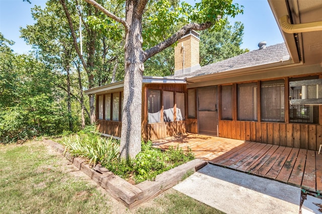 exterior space with a sunroom and a deck