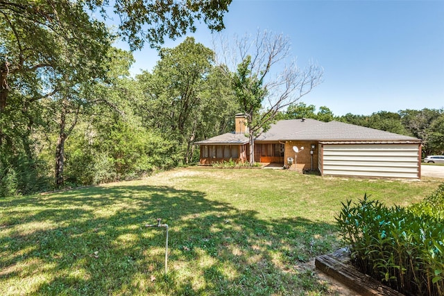 view of front of property with a garage and a front lawn