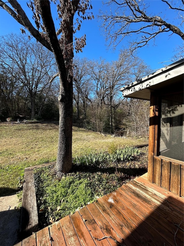 wooden terrace with a yard