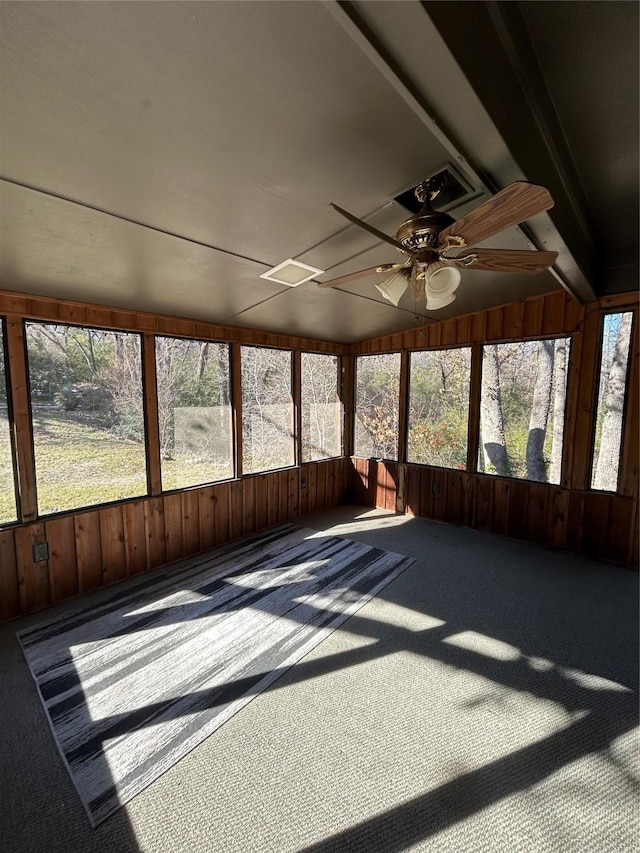 unfurnished sunroom with a wealth of natural light and ceiling fan