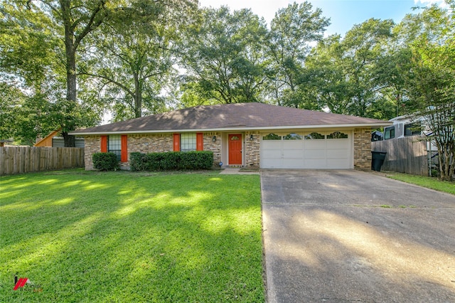 ranch-style house featuring a garage and a front lawn