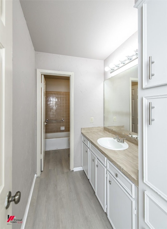 bathroom with vanity and wood-type flooring