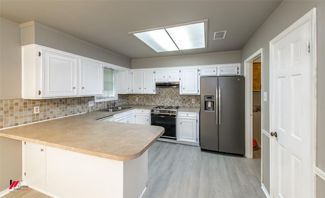 kitchen featuring stainless steel fridge with ice dispenser, range with gas stovetop, white cabinetry, sink, and kitchen peninsula