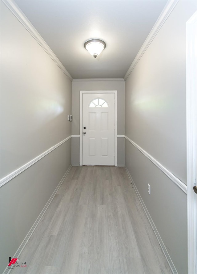 doorway with crown molding and light hardwood / wood-style flooring