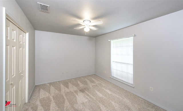 carpeted empty room with ceiling fan