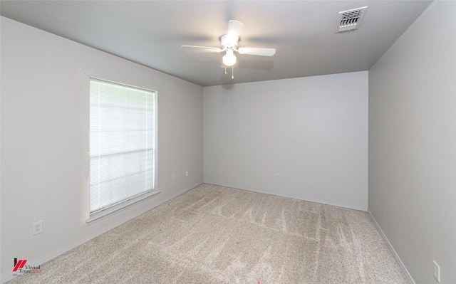 spare room featuring carpet floors and ceiling fan