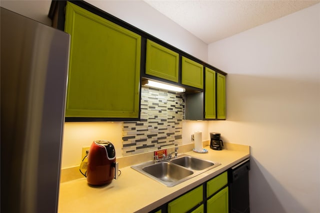 kitchen with stainless steel fridge, sink, green cabinetry, and black dishwasher