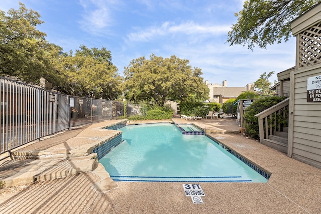 view of swimming pool featuring a patio area