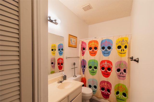 bathroom featuring curtained shower, vanity, and toilet