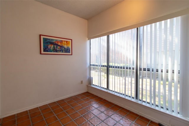 tiled spare room with a healthy amount of sunlight