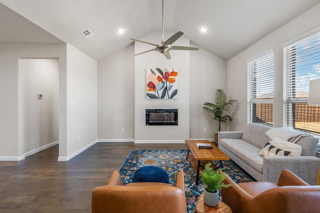 living room with ceiling fan, dark hardwood / wood-style flooring, and vaulted ceiling