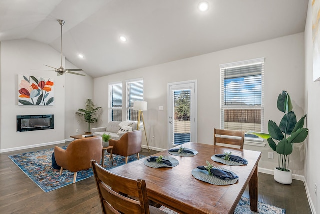 dining area featuring dark hardwood / wood-style flooring, lofted ceiling, and ceiling fan