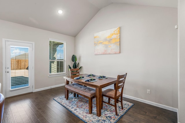 dining room with lofted ceiling and dark wood-type flooring