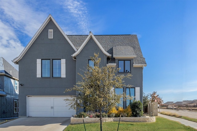 view of front of home featuring a front yard and a garage