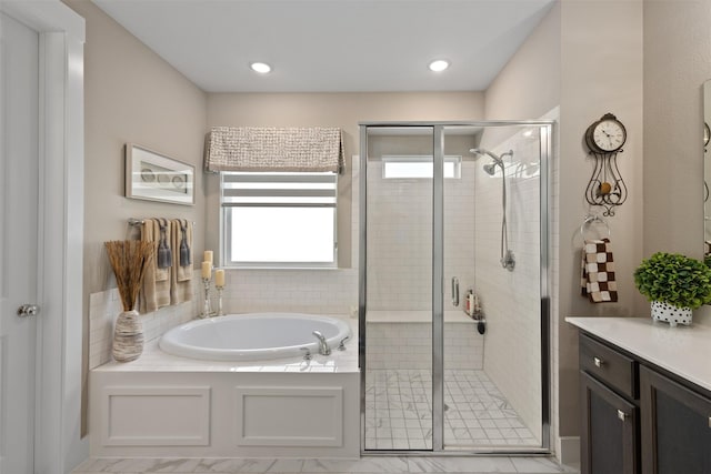 bathroom with vanity, independent shower and bath, and a wealth of natural light