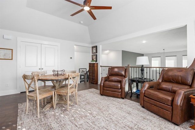 living room featuring hardwood / wood-style floors, ceiling fan, and lofted ceiling