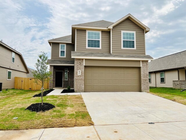 view of front of property featuring a front yard and a garage