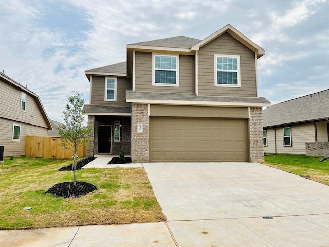 view of front of home with a garage and a front yard