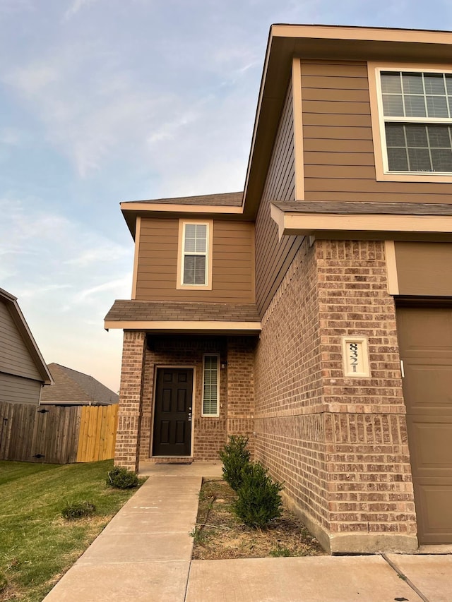 exterior entry at dusk with a garage