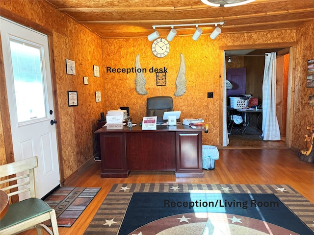 home office with track lighting and wood finished floors
