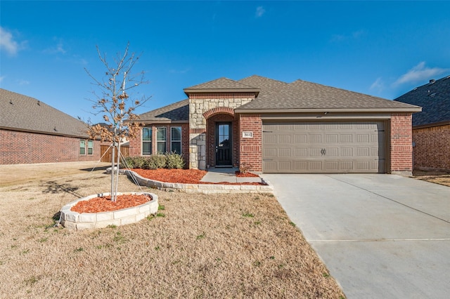 view of front of home featuring a garage and a front lawn