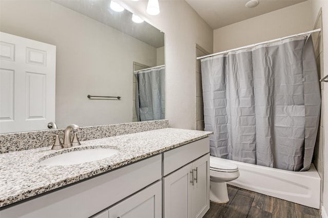 full bathroom featuring vanity, hardwood / wood-style floors, shower / bath combination with curtain, and toilet