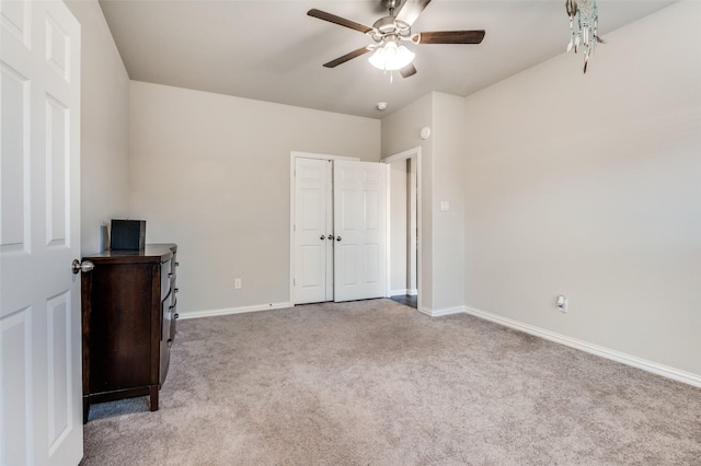 unfurnished bedroom featuring carpet flooring, ceiling fan, and a closet