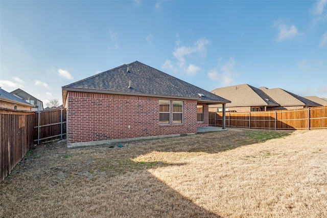 rear view of property with a yard