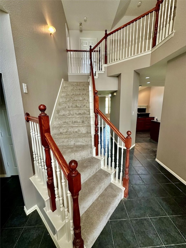 stairs featuring tile patterned floors and baseboards