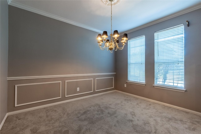 carpeted empty room featuring a chandelier and ornamental molding