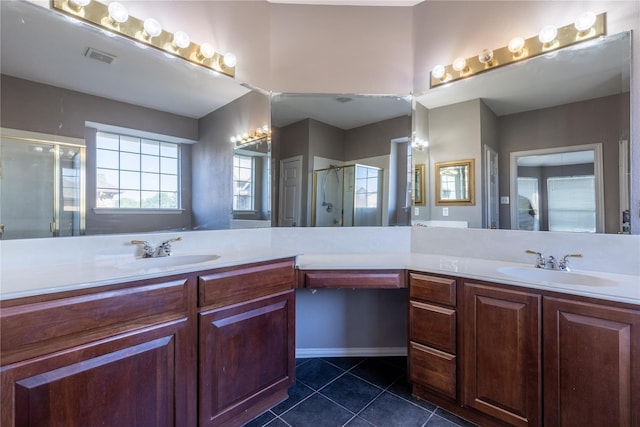 bathroom with tile patterned flooring, vanity, and an enclosed shower