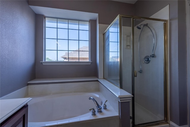 bathroom with vanity and independent shower and bath