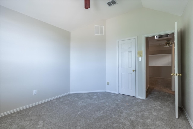 unfurnished bedroom featuring dark colored carpet, ceiling fan, and lofted ceiling