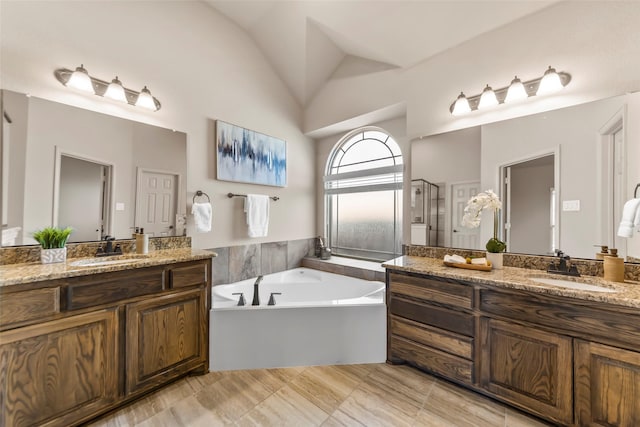 bathroom featuring lofted ceiling, vanity, and plus walk in shower