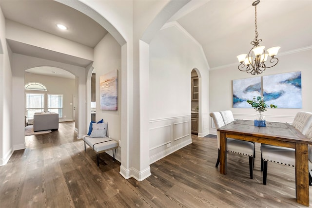 dining room featuring an inviting chandelier, ornamental molding, and dark wood-type flooring