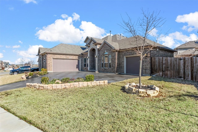 view of front of home with a front lawn and a garage