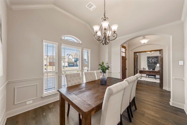 dining room with lofted ceiling, dark wood-type flooring, and crown molding