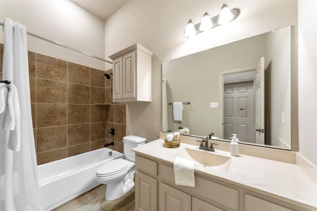 full bathroom with toilet, vanity, and tiled shower / bath combo