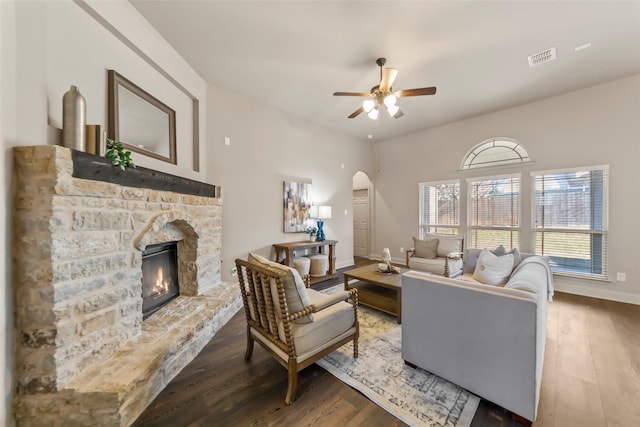 living room with wood-type flooring, a fireplace, and ceiling fan