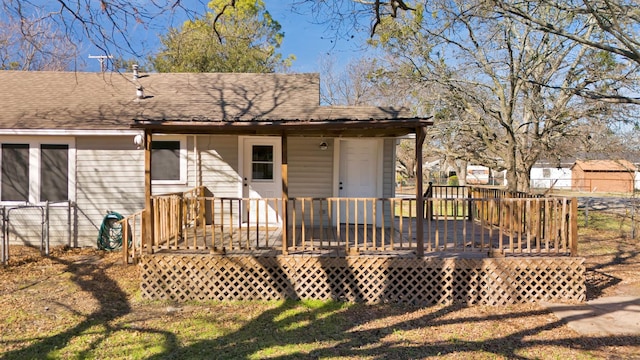 back of property with a wooden deck