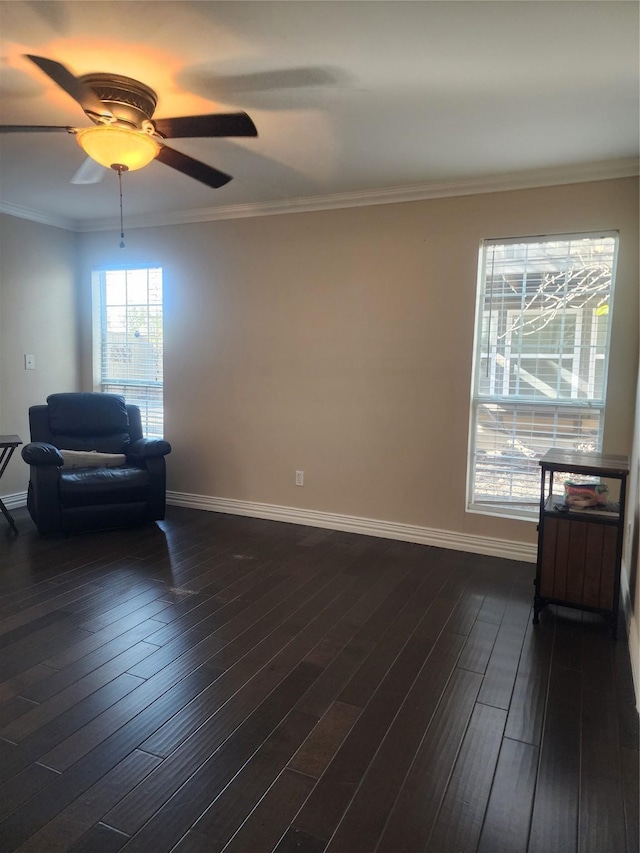 living area with ornamental molding, ceiling fan, and dark hardwood / wood-style floors