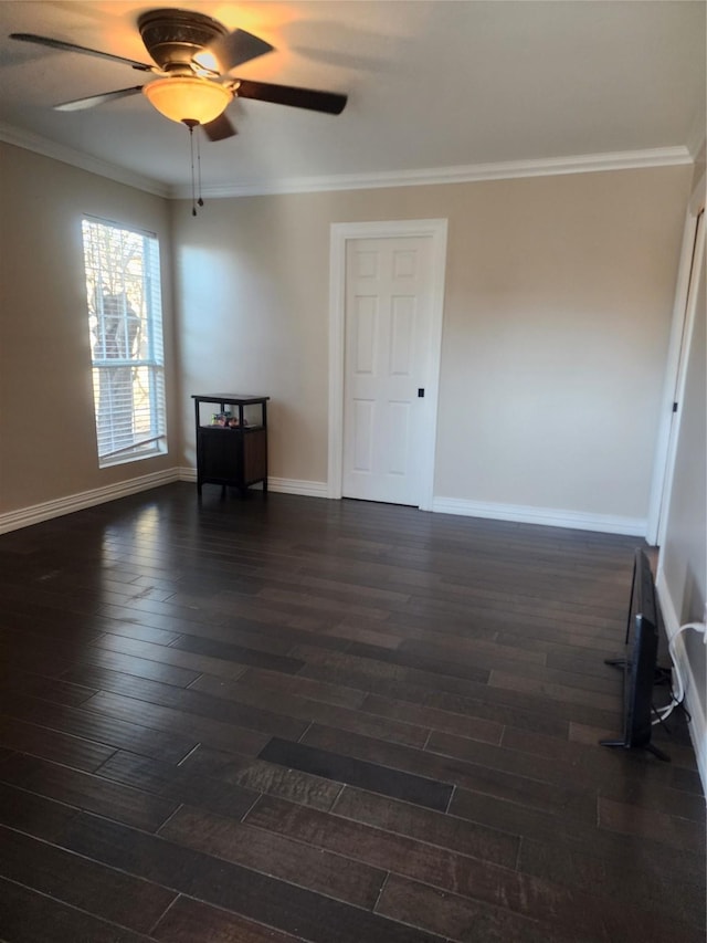 empty room featuring ceiling fan, dark hardwood / wood-style flooring, and crown molding