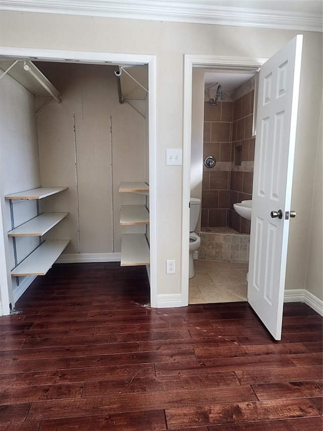 walk in closet featuring dark wood-type flooring