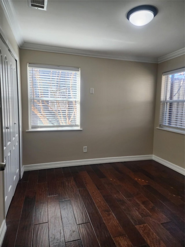 unfurnished room featuring ornamental molding and dark hardwood / wood-style floors