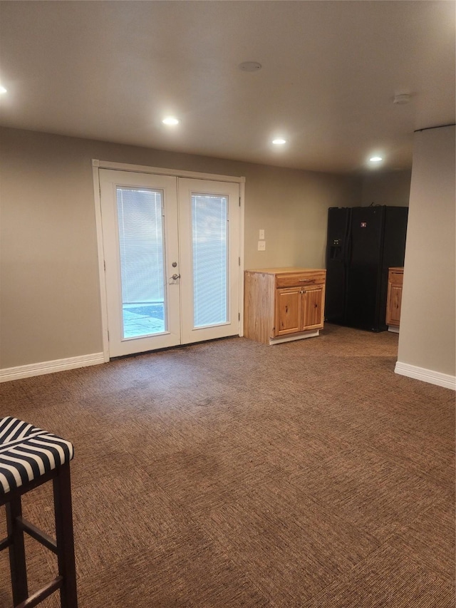 unfurnished living room with french doors and dark carpet