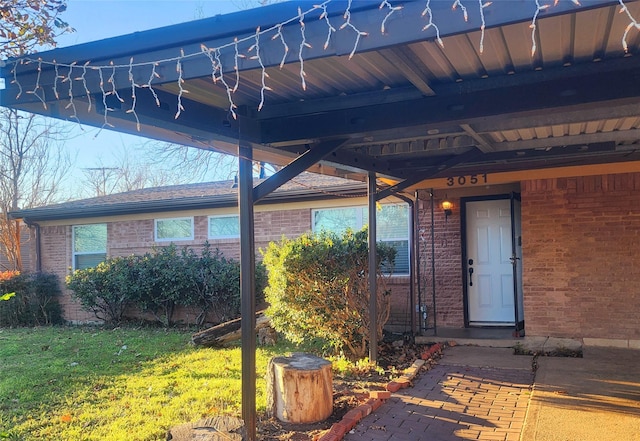 entrance to property featuring a lawn